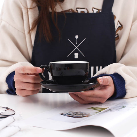 Coffeezone latte art saucer in glossy black bone china complements cappuccino presentation.
