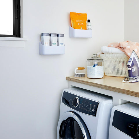 Caddy holding spray bottles in a closet for easy access