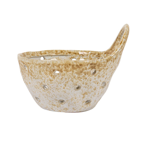Creative Co-Op beige stoneware colander placed on bar cart for display