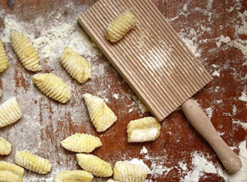 Cuisinox gnocchi ridges in action on dough.