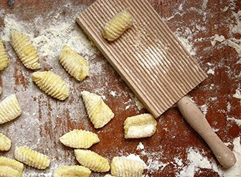 Cuisinox gnocchi ridges in action on dough.