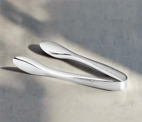 Cuisinox polished hammered stainless steel tongs ideal for formal entertaining and easy cleaning.