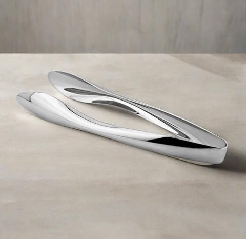 Cuisinox 6 inch tongs on a dining setting for effortless portion control