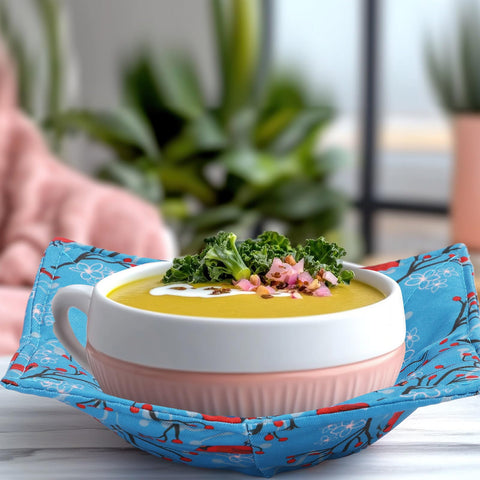 Cunhill hand holding a hot bowl with a holder for safety
