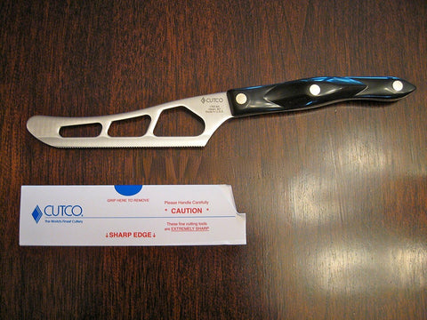 Cutco cheese knife showing perforated blade to prevent sticking on dense cheeses.