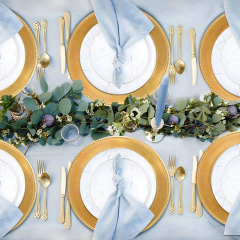 DaCakeWS wedding table setup featuring beaded gold chargers