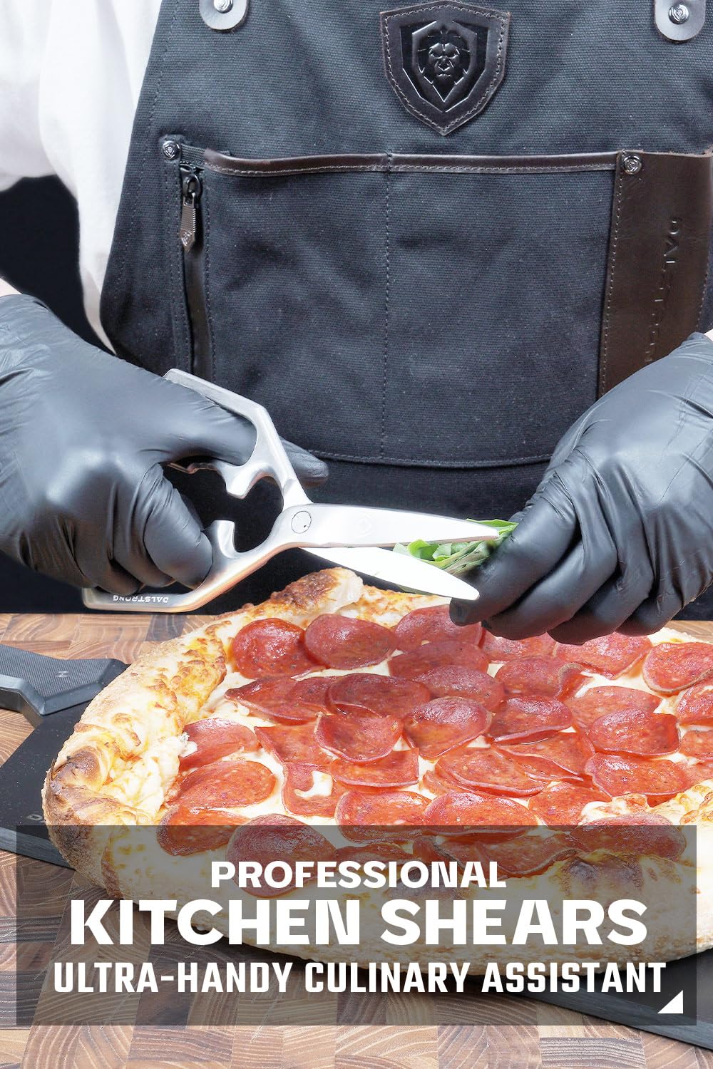 Dalstrong kitchen scissors slicing pizza neatly for quick servings.