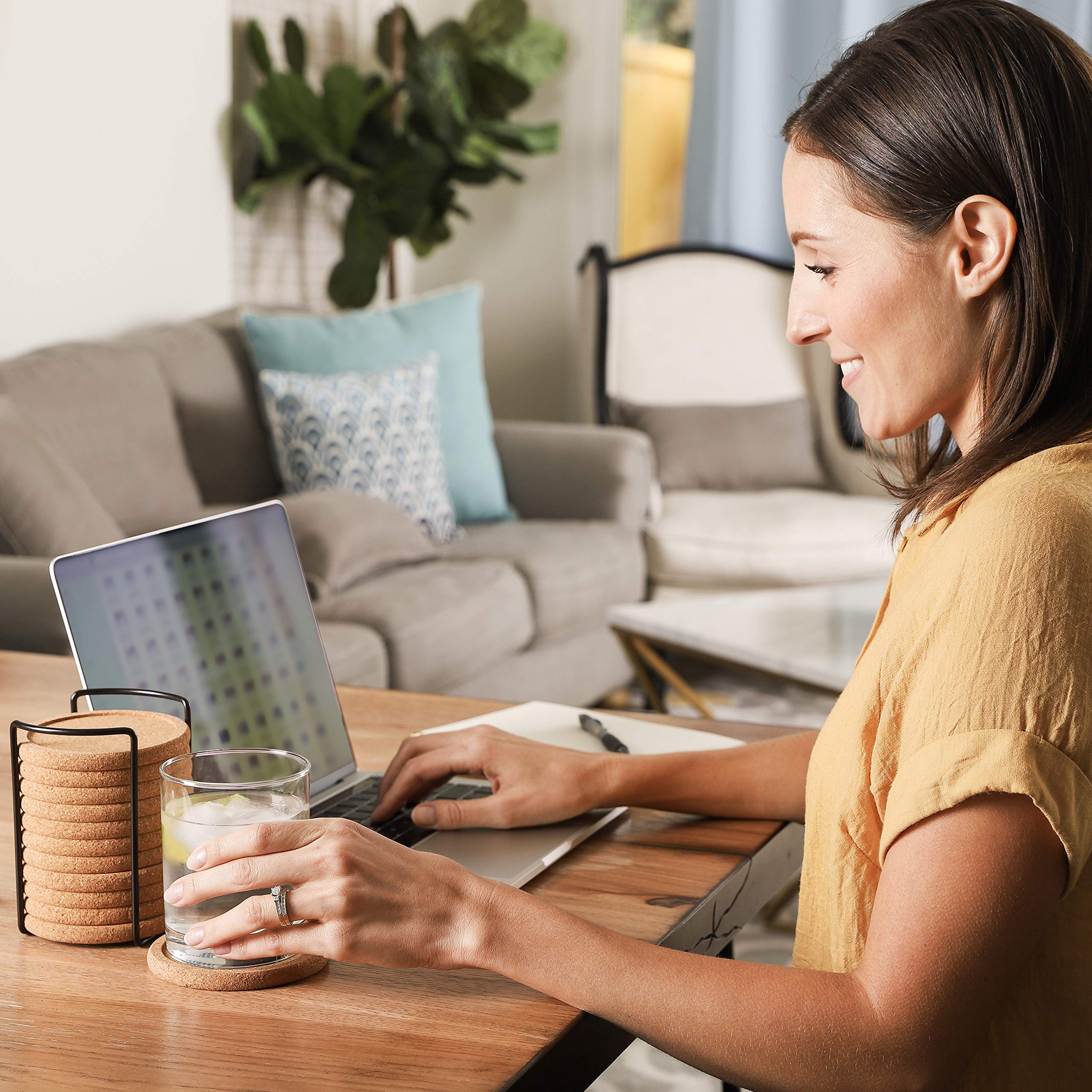Decopom coaster with metal holder keeps set neatly stored.