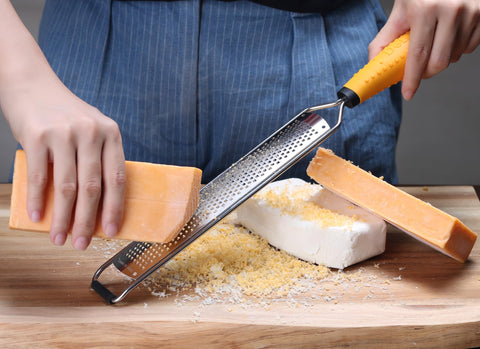 Deiss PRO parmesan cheese grater producing fluffy, melt-ready cheese for pasta.