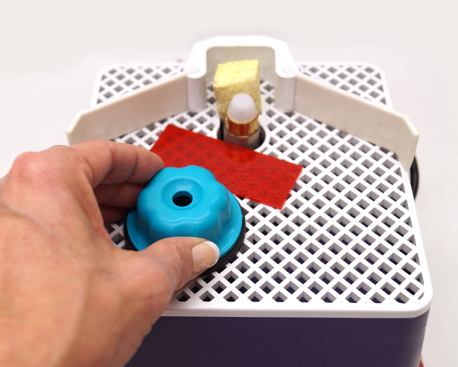 Delphi Glass Grinder Cookie in action shows glass is held for even pressure during grinding.