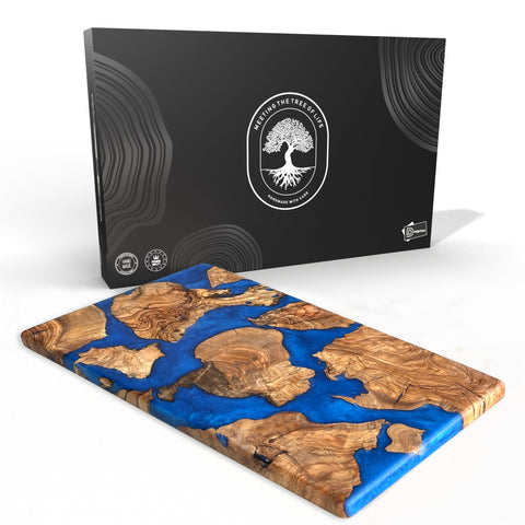 Designium olive wood resin cutting board close-up showing dense grain for longevity.