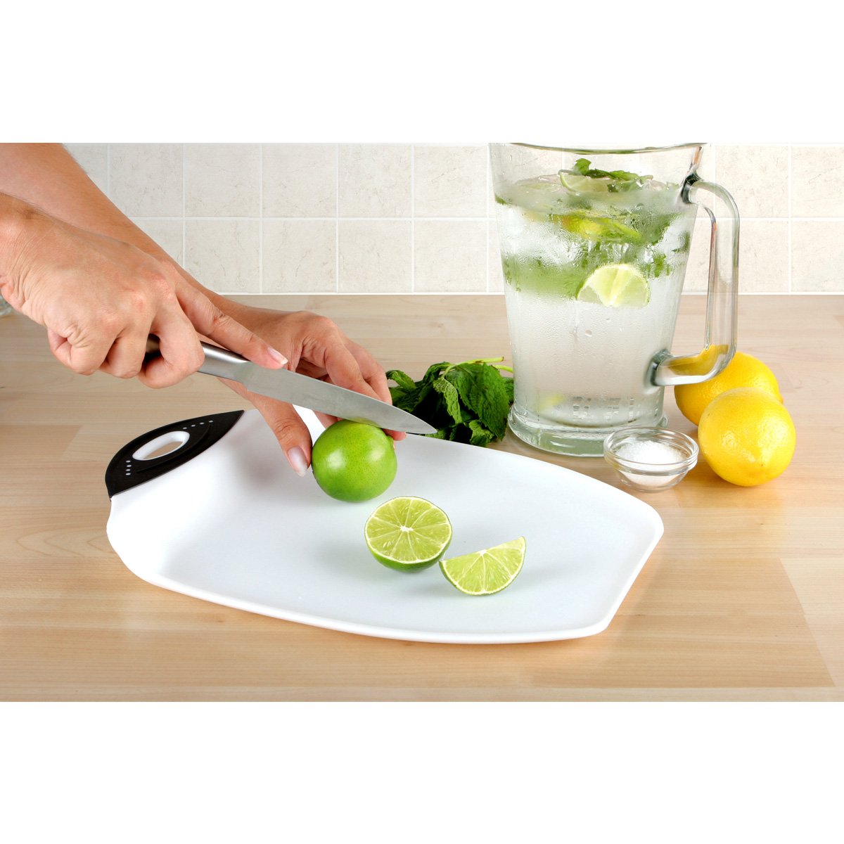 Dexas Chop & Scoop board shown stable by non-slip feet during chopping