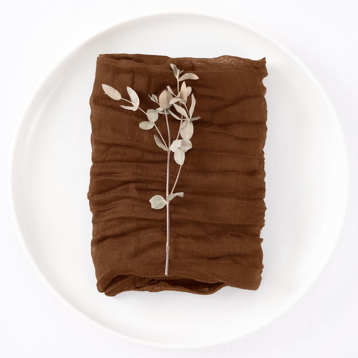 DeZerlor napkins folded into rose or pocket shapes for elegant place settings