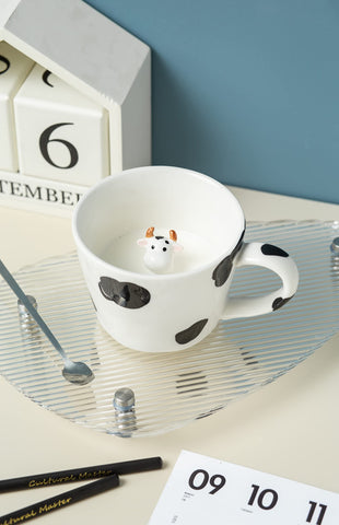 DIHOclub cow ceramic mug showcases black and white hand-drawn artwork.