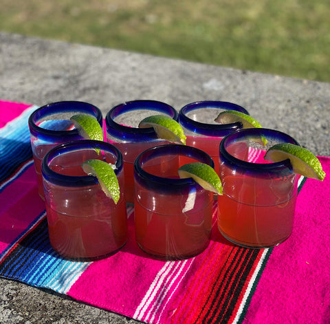 Dos Sueños cobalt blue rim 10oz tumbler shown in a set, ideal for festive gatherings.