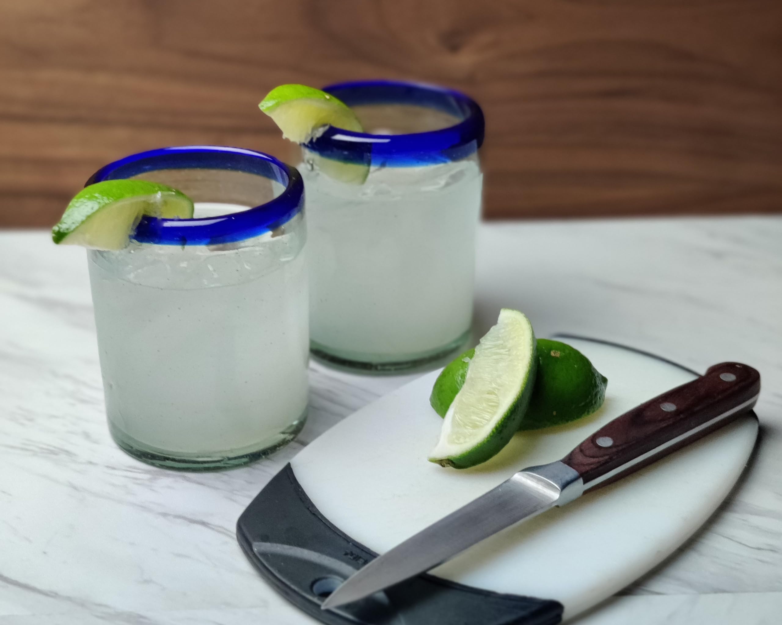 Dos Sueños hand-blown tumbler with cobalt blue rim, subtle variations.