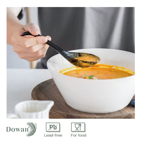 DOWAN ramen spoon in action with broth and dumplings.