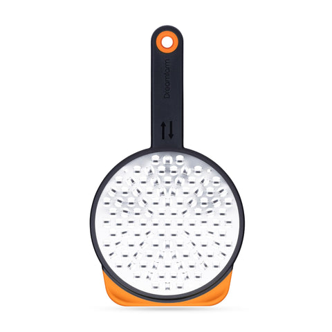 Dreamfarm Ograte bottom blades in circular motion for fast, even grating.
