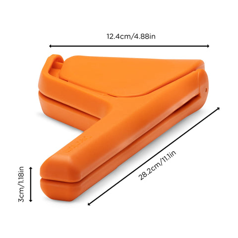 Dreamfarm original orange Fluicer, side-pivot design enabling ergonomic two-handed leverage during juicing.
