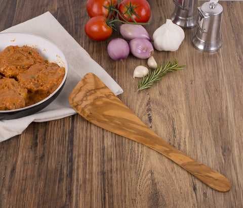Spatula tucked in a gadget drawer for organized kitchen tools