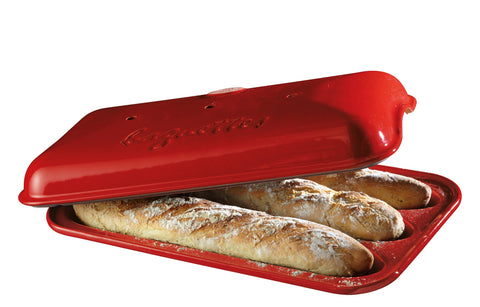 Emile Henry baguette baker with lid and dough rising for a light, crispy baguette.
