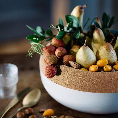 Fruit shown in the cork-top bowl of Emile Henry Blue Flame