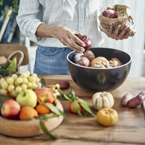Two-tier-design Emile Henry Deep Storage Bowl demonstrates organized fruit and veg storage