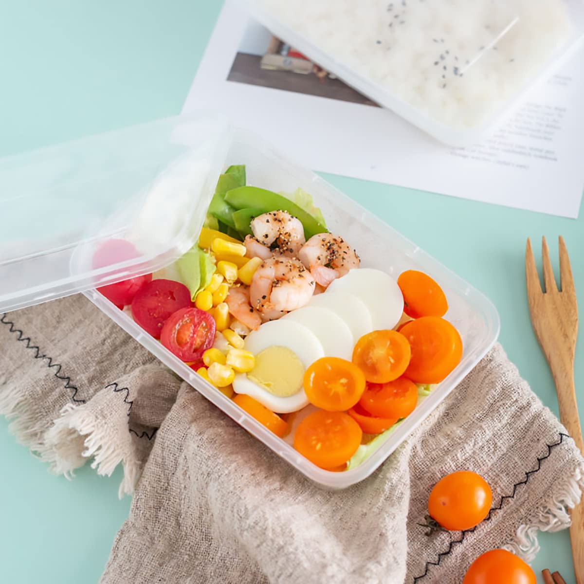 Assorted foods in Ensbelei meal prep containers for varied daily meals.