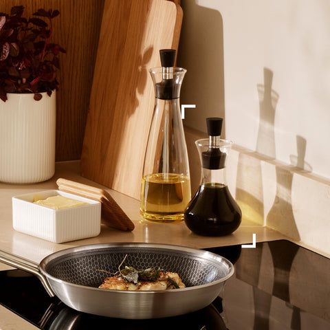 Eva Solo dressing shaker used over a bowl for controlled pouring.