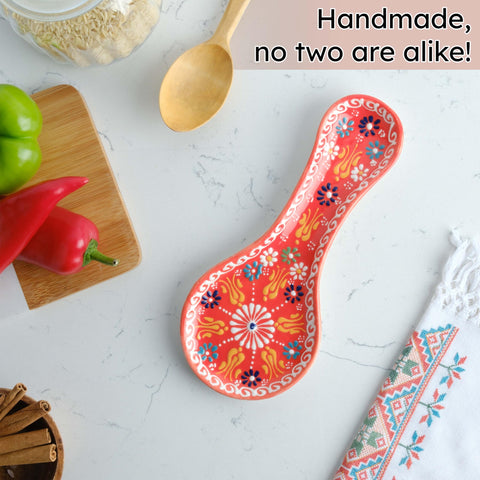 Evanilife orange spoon rest on stovetop keeps utensils tidy.