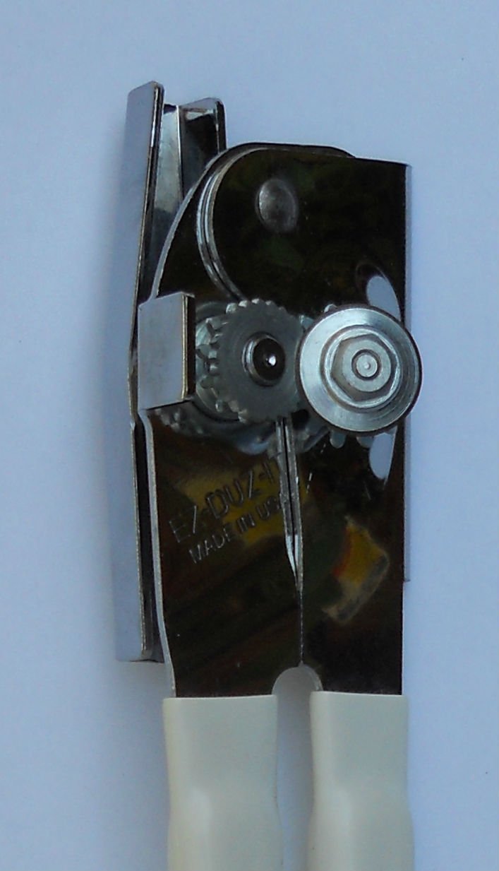 EZ-DUZ-IT can opener white blade close-up shows carbon steel cutting edge