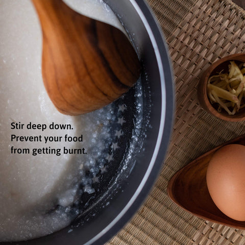FAAY teak spoon with wide tip for stirring and scraping.