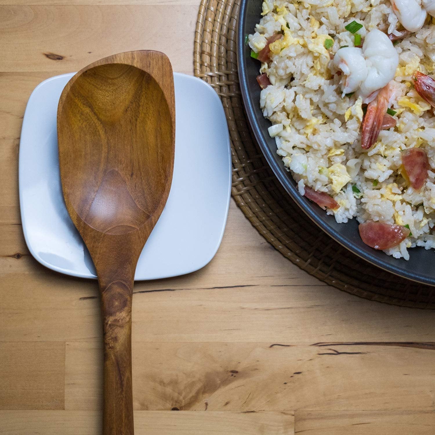 FAAY artisan-made teak spoon showing natural color variations.