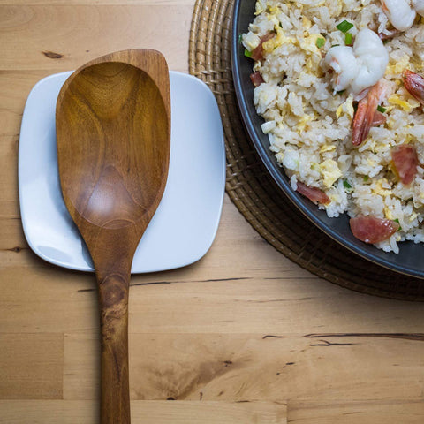 FAAY artisan-made teak spoon showing natural color variations.