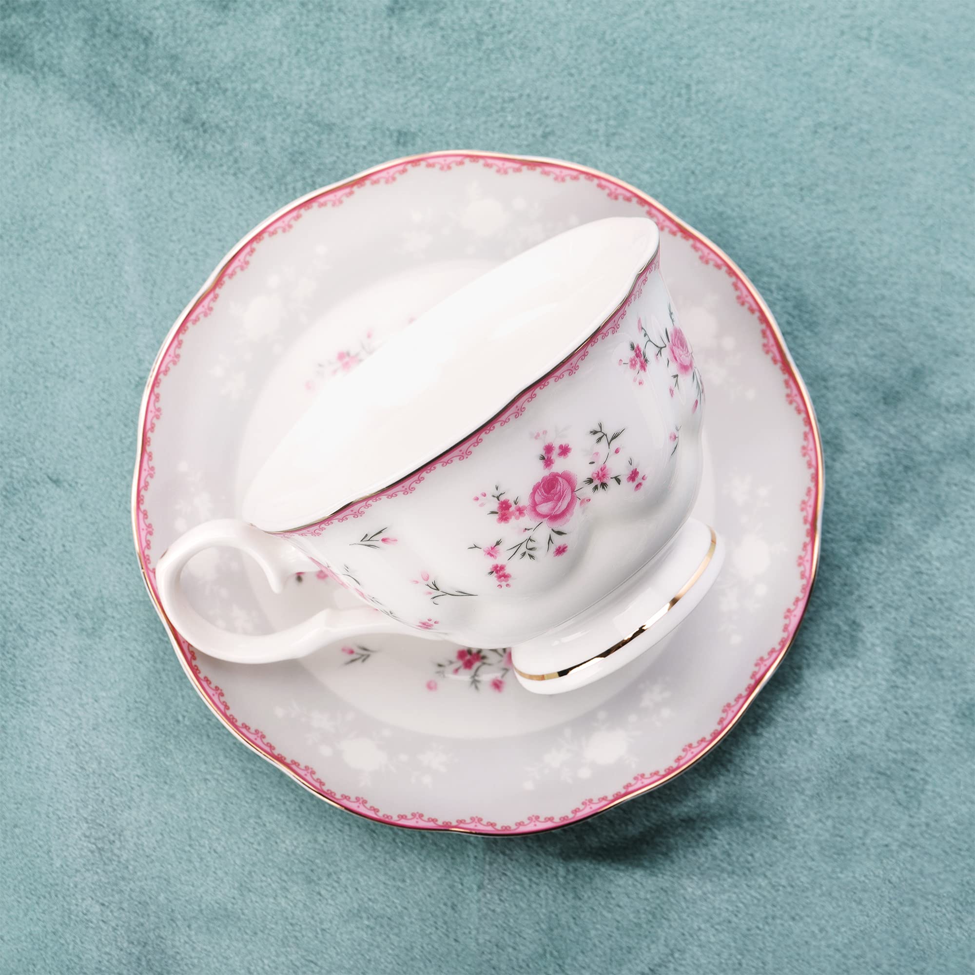 Fanquare porcelain saucers feature delicate rose motif, keep cups stable during tea time.
