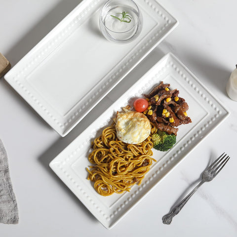 Feenmai dinner party serving plates present food elegantly at table.