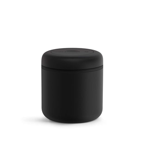 Fellow Atmos vacuum coffee canister in matte black shows its 0.7L capacity for fresh beans.