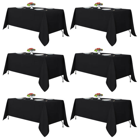 Fitable black tablecloth rectangle 6-pack stacked for easy setup and elegance.