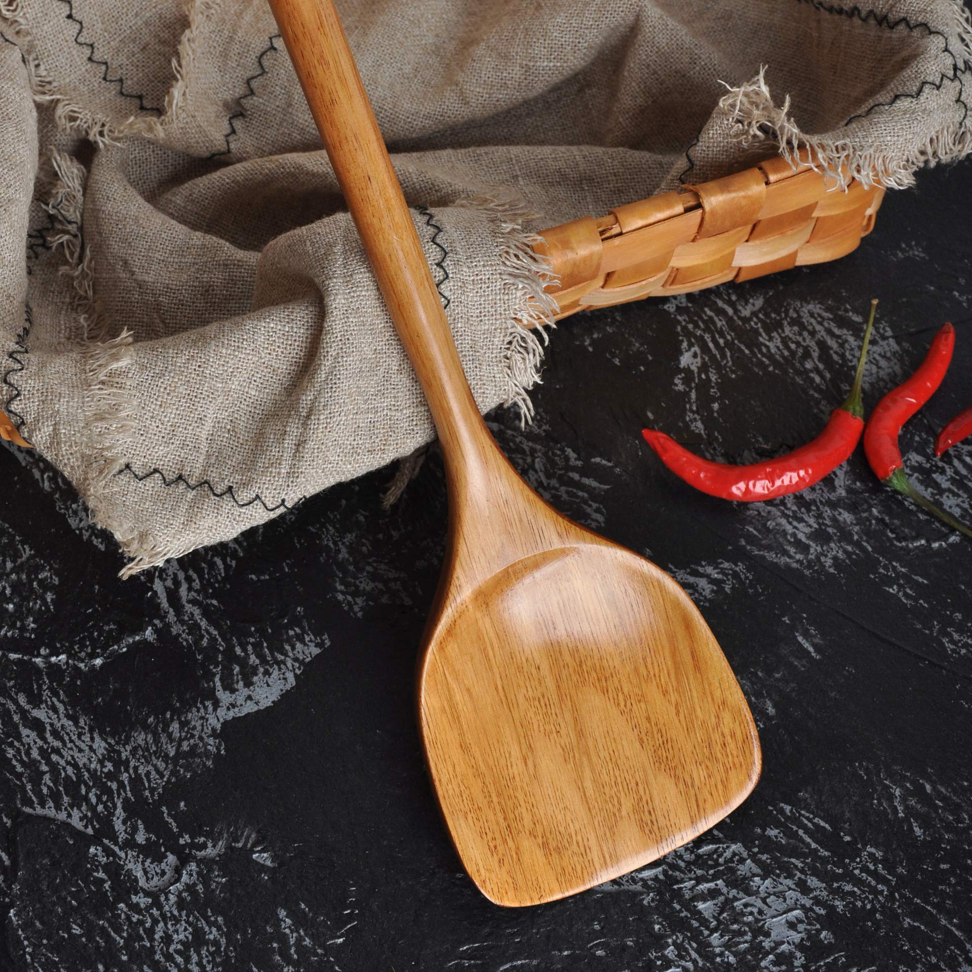 FJNATINH spatula on nonstick cookware highlighting scratch-free use.