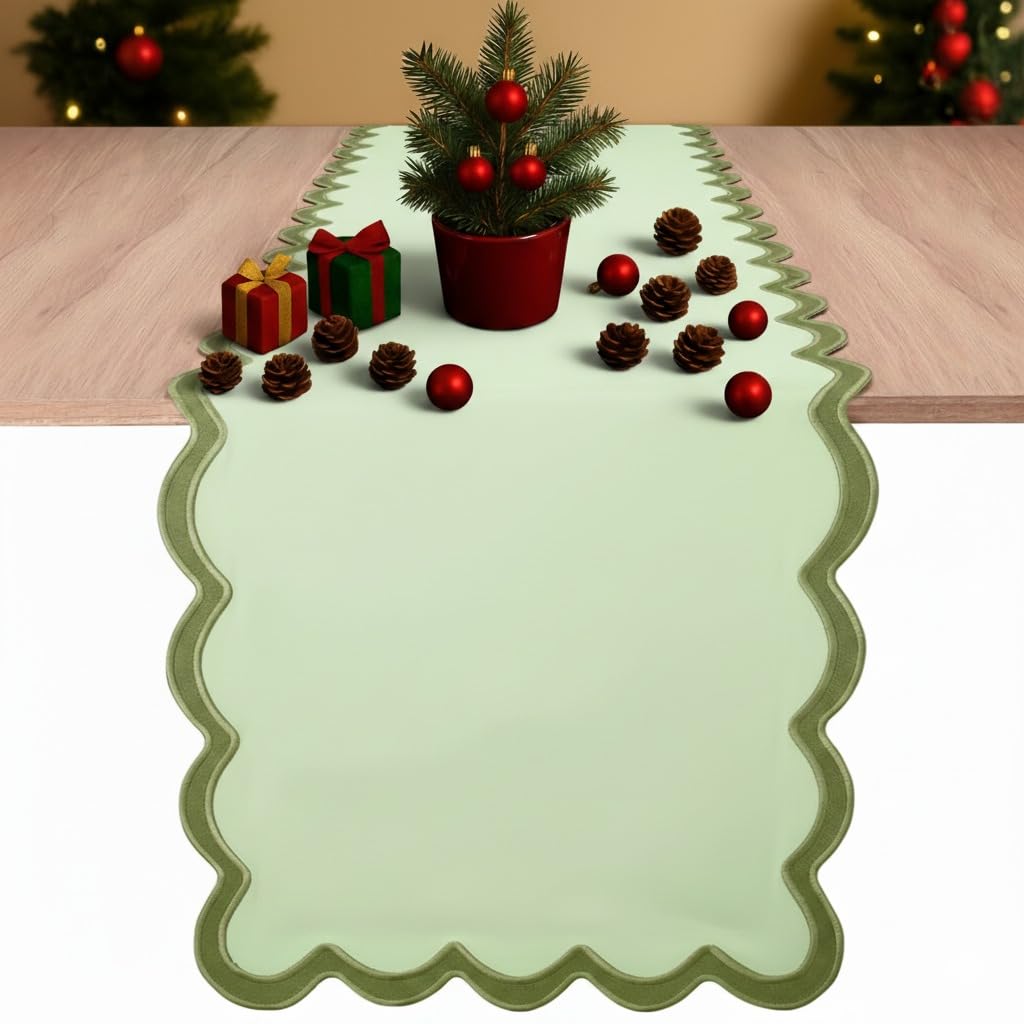 Folkulture table runner scalloped sage green on a dining table for elegant dining ambiance.