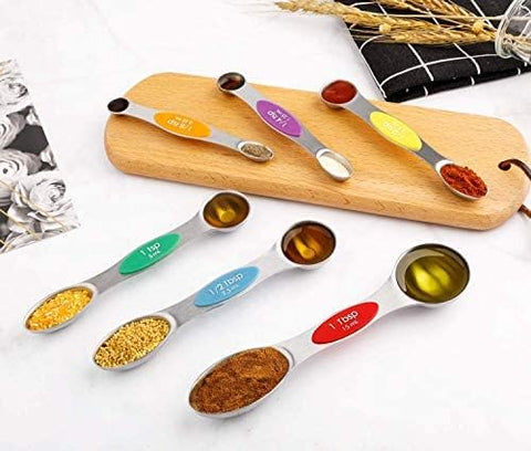 Forkmannie double-ended spoons designed for dry and liquid ingredients with spill-resistant bases.