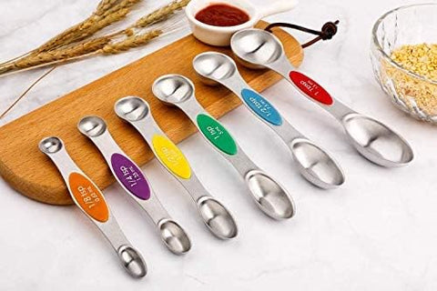 Forkmannie spoons stacked in drawer demonstrate space-saving magnetic storage.