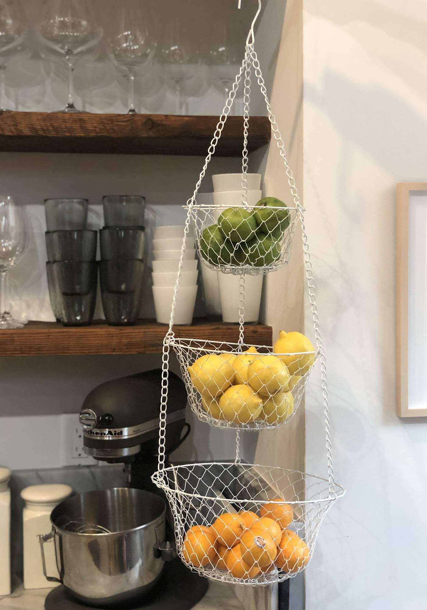 Fox Run white 3-tier baskets in kitchen show seven-to-eleven inch capacity.