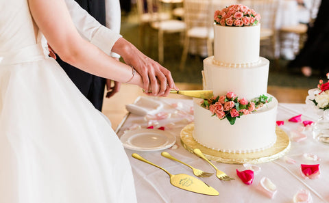 Galaxozent cake knife and server engraved MR and MRS showcased on dessert tray.