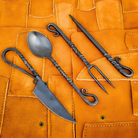 Generic hand-forged medieval cutlery set front view, durable outdoor dining option.