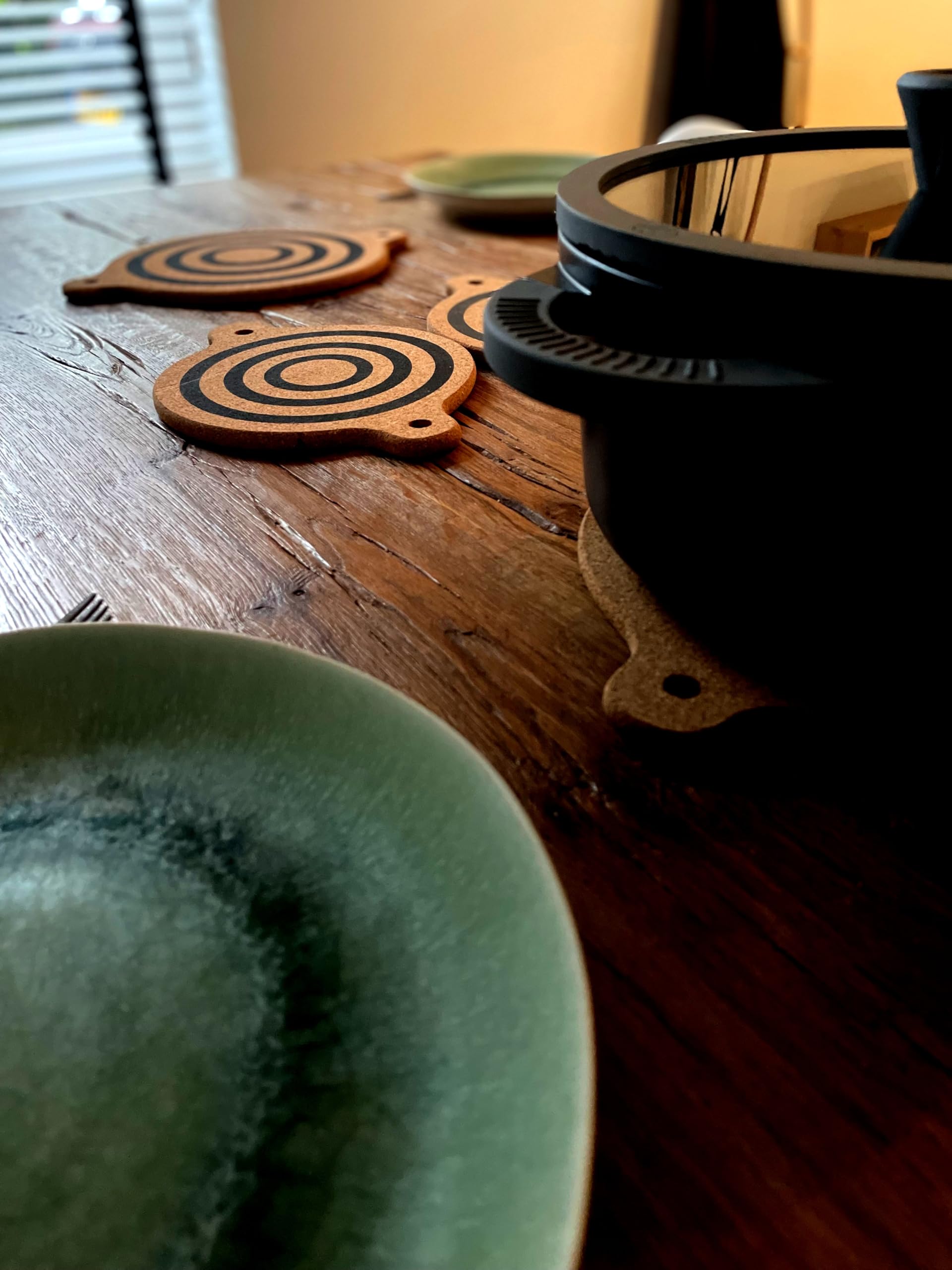 Generic magnet cork trivet storage hole keeps trivets handy in kitchen.