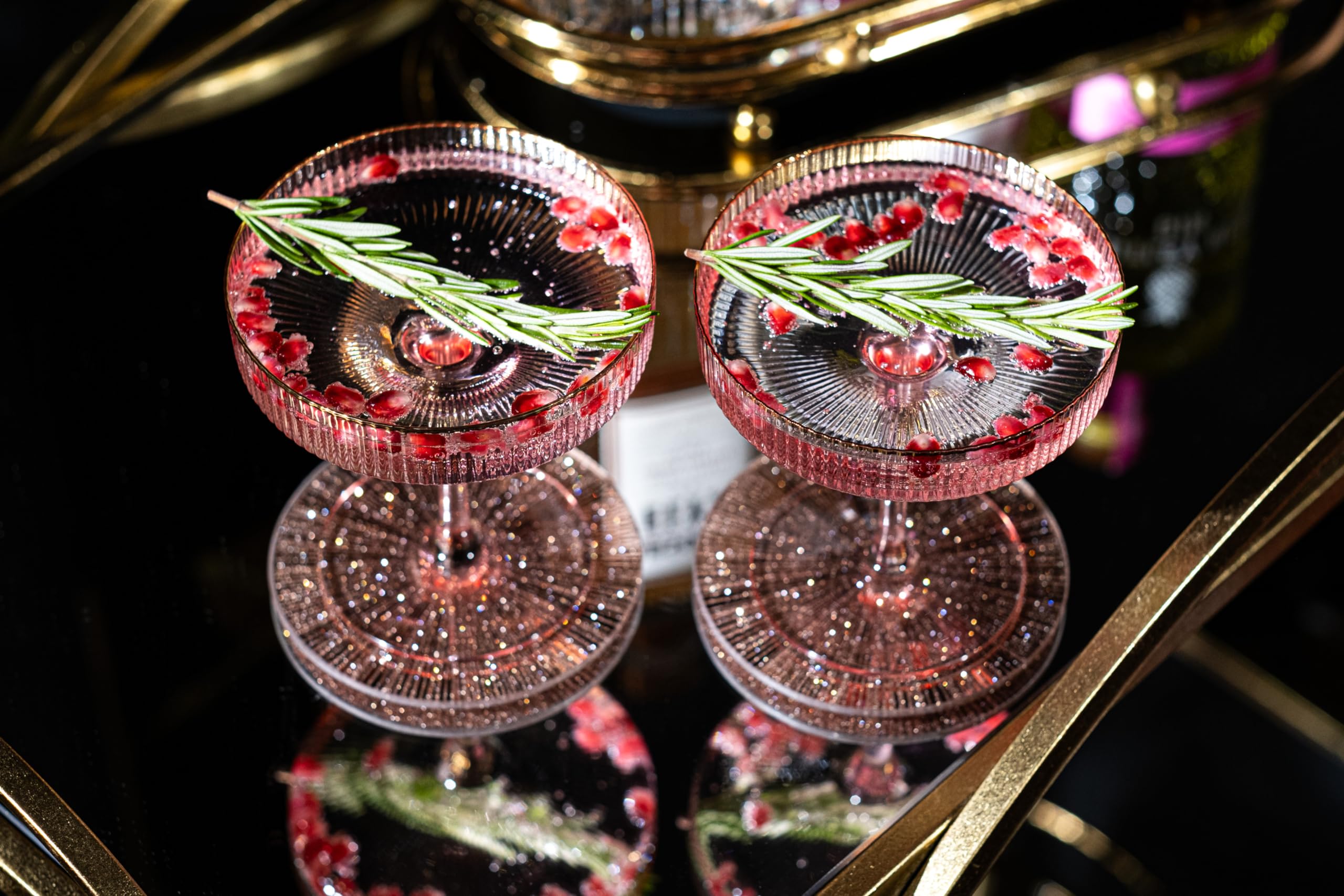 GLASSIQUE CADEAU close-up of gold rims on ribbed crystal coupe glasses.