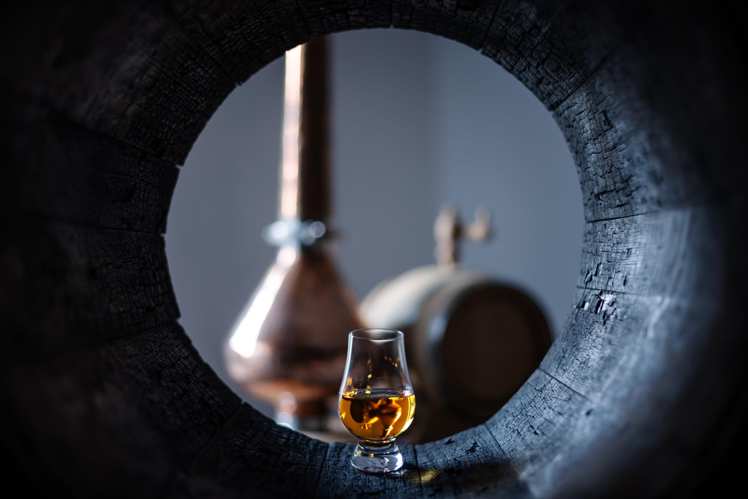GLENCAIRN whiskey glass pouring scene shows steady pour for savoring.