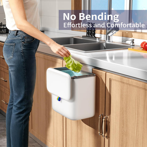 Gleynest compost bin hanging on cabinet door for easy access.