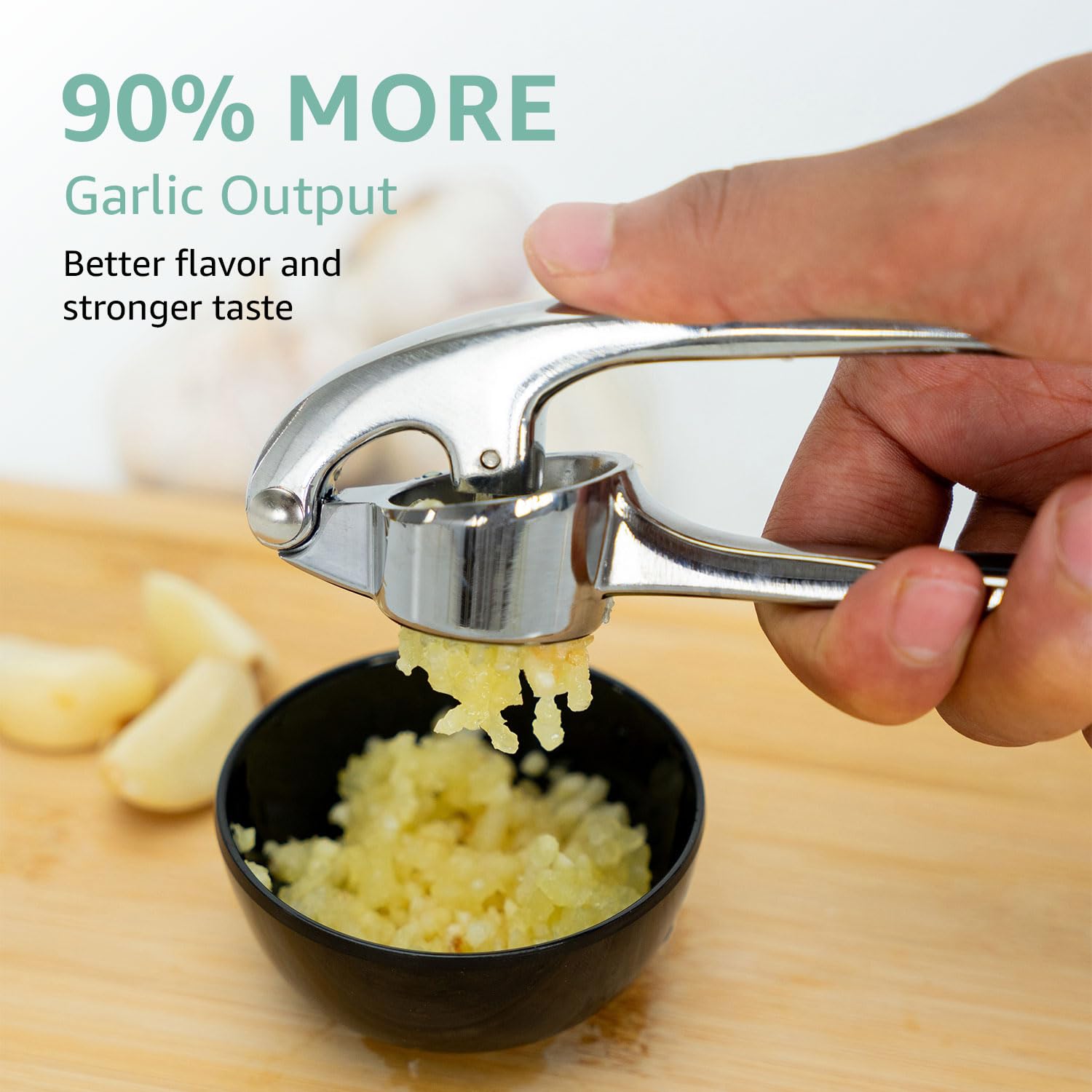 Open-design, dishwasher-safe garlic press beside sink for easy cleaning after cooking